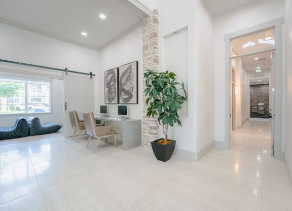 a living room and dining room with a large potted plant at Aldara Apartments in Saratoga Springs, Utah