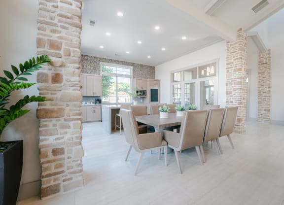 a dining room with a table and chairs in a large room at Aldara Apartments in Saratoga Springs, Utah