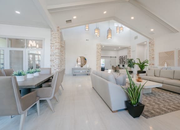 a living room and dining room with couches and a table at Aldara Apartments in Saratoga Springs, Utah