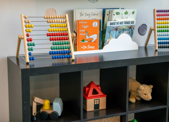 a childrens play room with toys and a wooden abacus at Aldara Apartments in Saratoga Springs, Utah