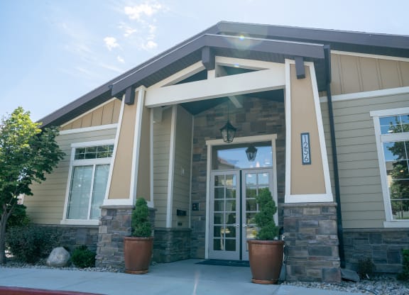 the front of a building with two potted plants in front of it at Aldara Apartments in Saratoga Springs, Utah