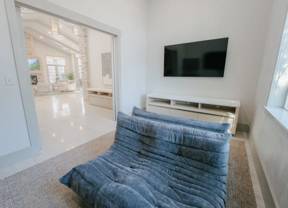 a living room with a blue couch and a tv at Aldara Apartments in Saratoga Springs, Utah