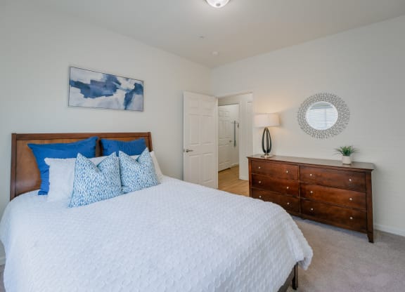 a bedroom with a large bed and a dresser at Aldara Apartments in Saratoga Springs, Utah