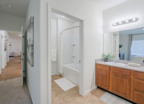 a bathroom with a shower and a sink and a mirror at Aldara Apartments in Saratoga Springs, Utah
