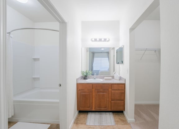 a bathroom with a sink and a shower and a mirror at Aldara Apartments in Saratoga Springs, Utah
