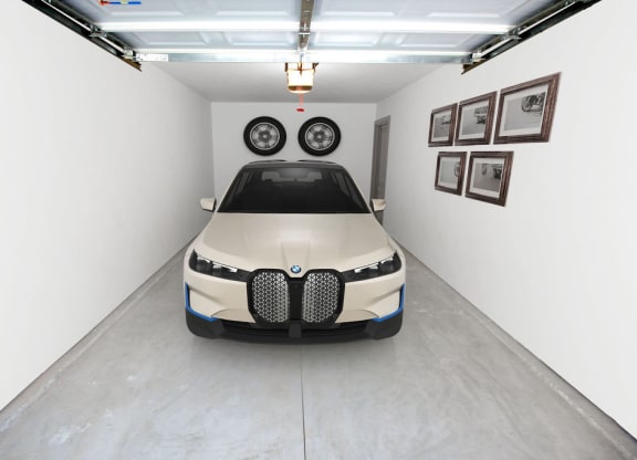 a car parked in a garage with two tires on top of it