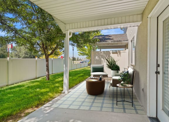 a patio with a chair and a table on it
