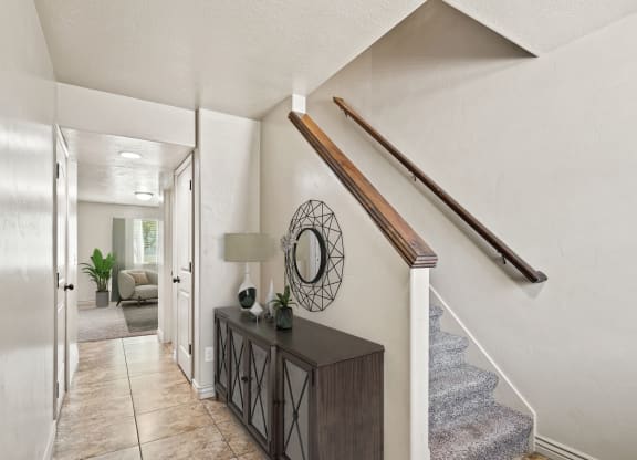 theoyer of a house with stairs and a hallway with a table and a mirror