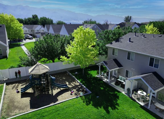 a aerial view of a backyard with a playground and houses