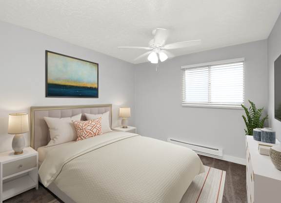 A bedroom with a large bed, a ceiling fan, and a painting on the wall.