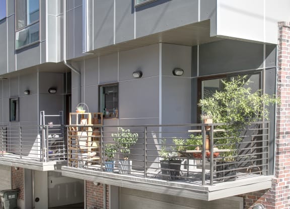 a balcony with a metal railing and plants on it at BlueKoi Townhomes for rent in Salt Lake City, UT