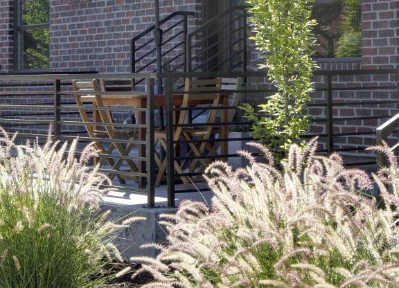a patio with a red umbrella and a table and chairs at BlueKoi Townhomes for rent in Salt Lake City, UT