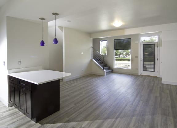 an empty kitchen and living room with a door to the backyard at BlueKoi Townhomes for rent in Salt Lake City, UT