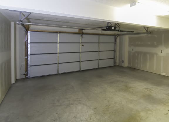 the inside of a garage with a white garage door at BlueKoi Townhomes for rent in Salt Lake City, UT