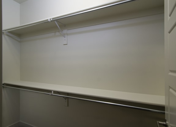an empty closet with a white wall and a sliding glass door at BlueKoi Townhomes for rent in Salt Lake City, UT
