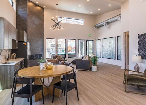A modern kitchen with a dining table and chairs.