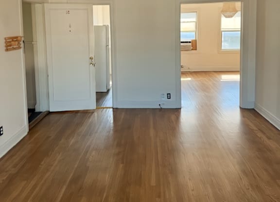 A room with wooden floors and white walls.