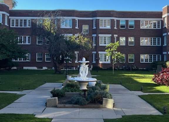 A large building with a fountain in front of it.