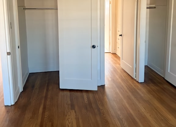 A room with white walls and wooden floors.