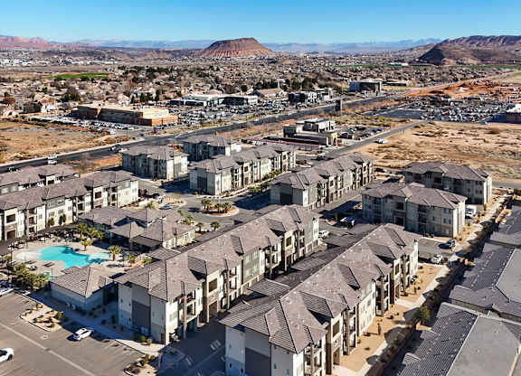 A large residential complex with a swimming pool in the middle.