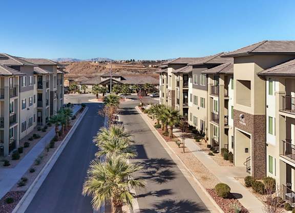 A street view of a residential area with apartment buildings on both sides.