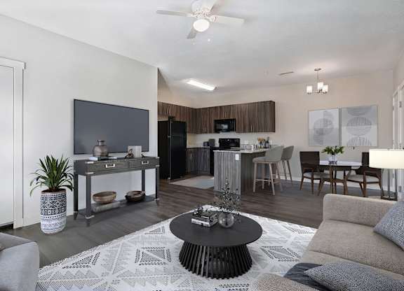 A modern living room with a grey couch and a black coffee table.
