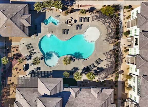 An aerial view of a residential area with a swimming pool.