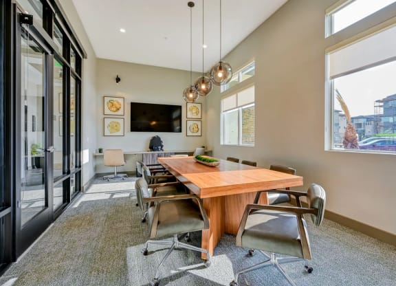 a large conference room with a beautiful wooden table and chairs at Brookfield Apartments for rent in St. George, UT. d