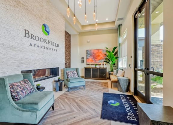 an apartment building lobby with couches and chairs at Brookfield Apartments for rent in St. George, UT.