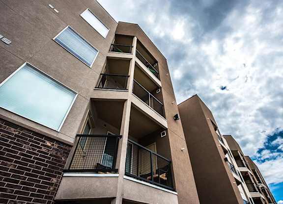 A tall apartment building with balconies and windows.