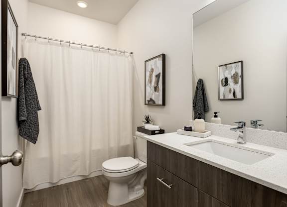 A bathroom with a white toilet and a white sink.