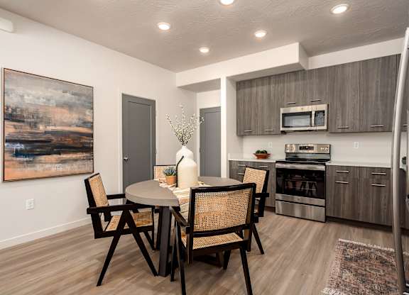 A modern dining room with a table set for two.