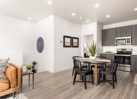 A modern kitchen with a dining table and chairs.