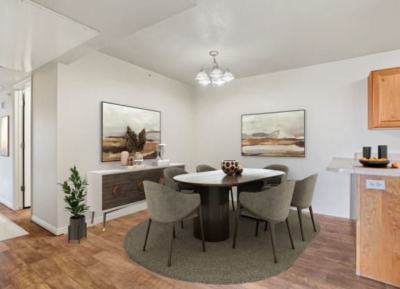 a dining room with a round table and chairs
