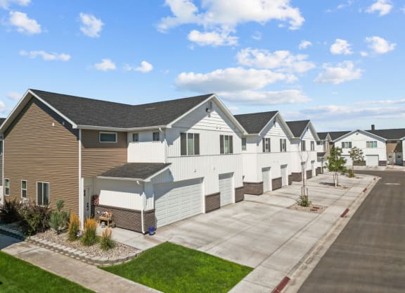 a row of white and brown houses on a street