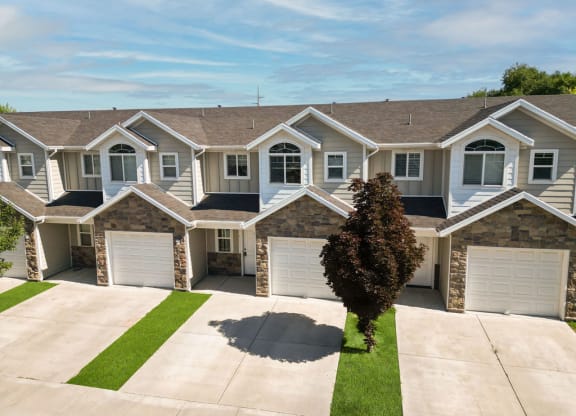 a house with three garage doors on a driveway