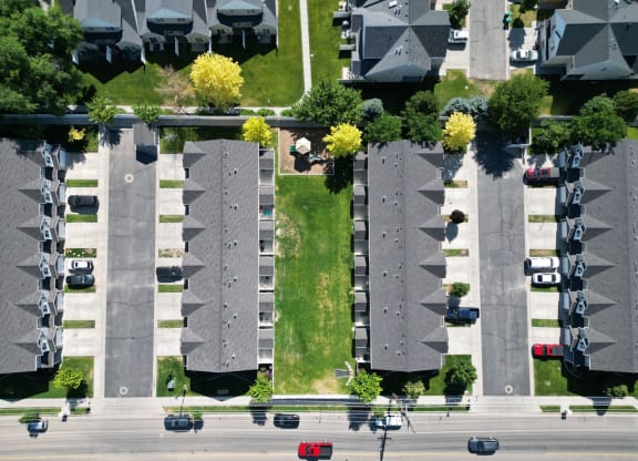 an aerial view of a parking lot with rows of houses