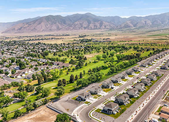 A suburban neighborhood with houses and a mountain range in the background.
