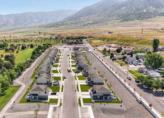 A suburban neighborhood with houses and a mountain range in the background.