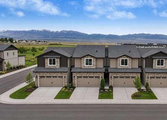 A row of houses with garages in front of them.
