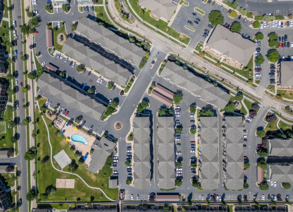 an aerial view of a parking lot and cars in a parking at Aldara Apartments in Saratoga Springs, Utah