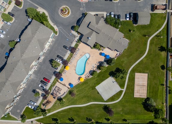 an aerial view of a neighborhood with a swimming pool in the middle of a street at Aldara Apartments in Saratoga Springs, Utah