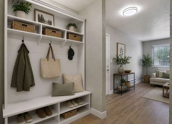 A white shelving unit with baskets and shoes on it.