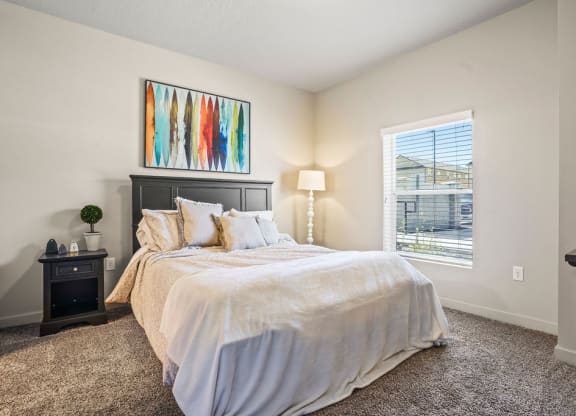 a bedroom with a large bed and a window