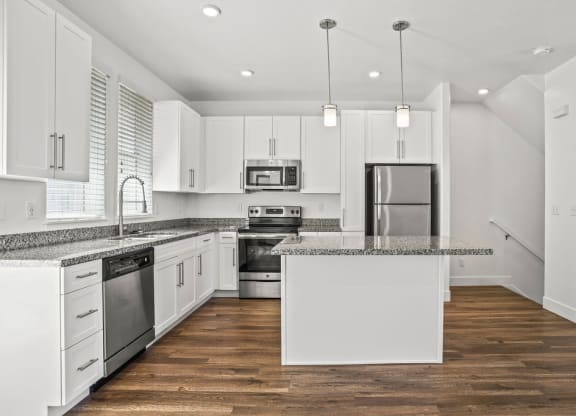 a kitchen with white cabinets and a counter top at Aero Luxury Townhomes in Layton, Utah