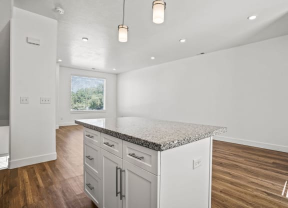 a white kitchen with a marble counter top  at Aero Luxury Townhomes in Layton, Utah