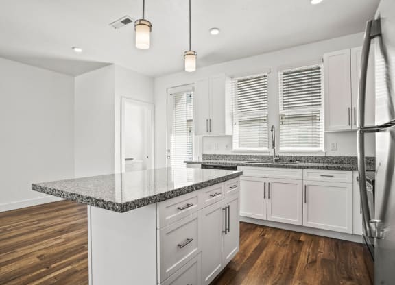 a kitchen with white cabinets and a counter top  at Aero Luxury Townhomes in Layton, Utah