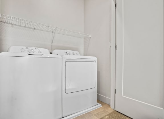 an empty laundry room with a washer and dryer in it  at Aero Luxury Townhomes in Layton, Utah