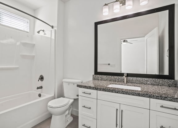 a bathroom with a sink toilet and a bath tub  at Aero Luxury Townhomes in Layton, Utah