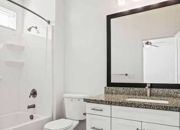 a bathroom with a toilet and a sink and a bath tub  at Aero Luxury Townhomes in Layton, Utah